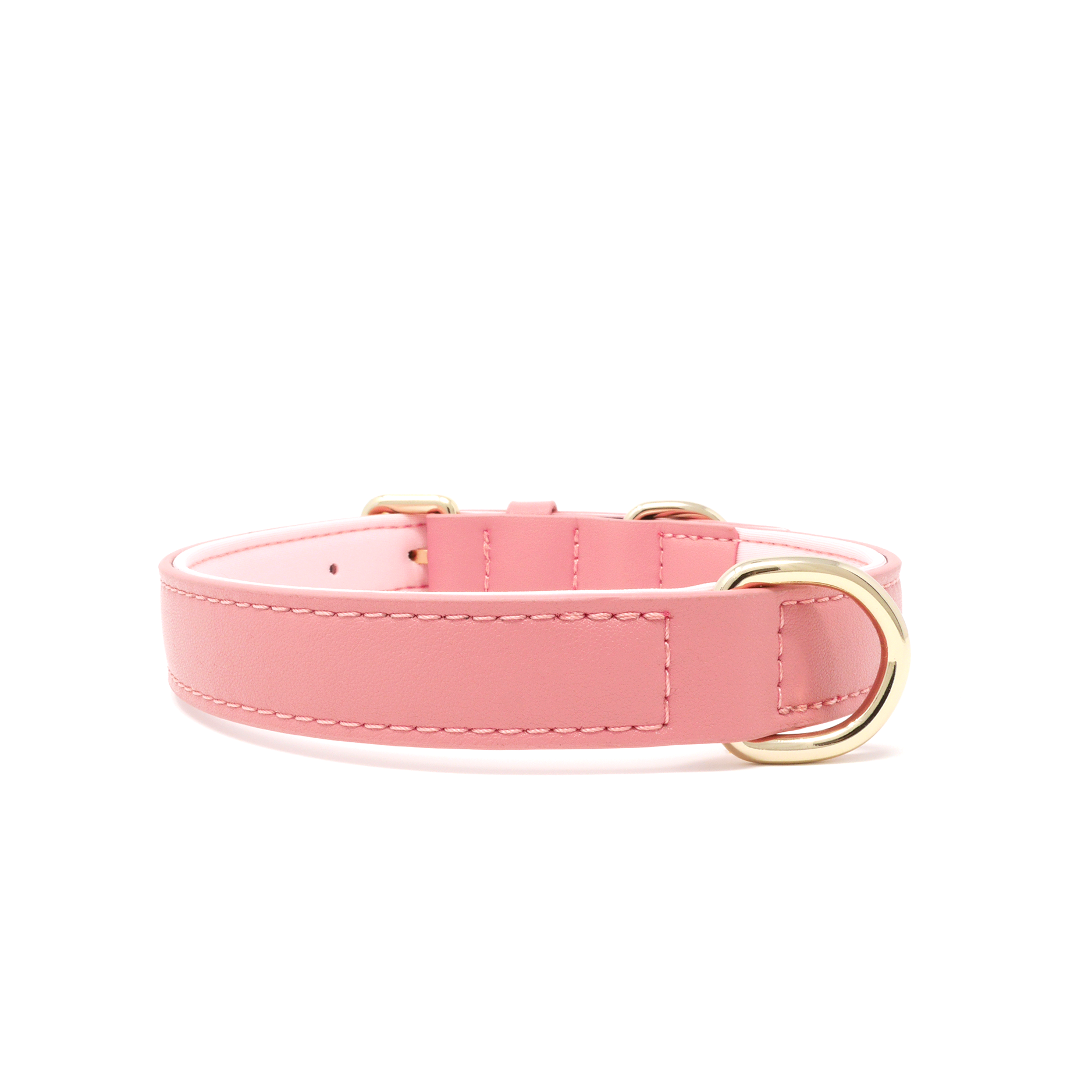 A pink vegan leather dog collar with gold-tone metal hardware, including a buckle, D-ring, and keeper, shown on a plain white background.