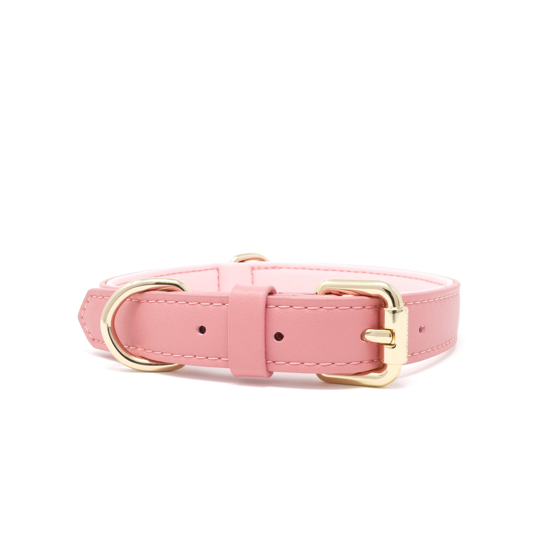 A pink vegan leather dog collar with gold-tone metal hardware, including a buckle, D-ring, and keeper, shown on a plain white background.