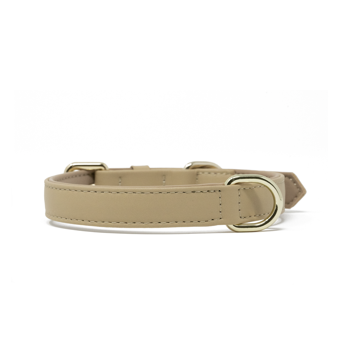 A Cream Beige vegan leather dog collar with silver-tone metal hardware, including a D-ring and buckle, shown against a plain white background.