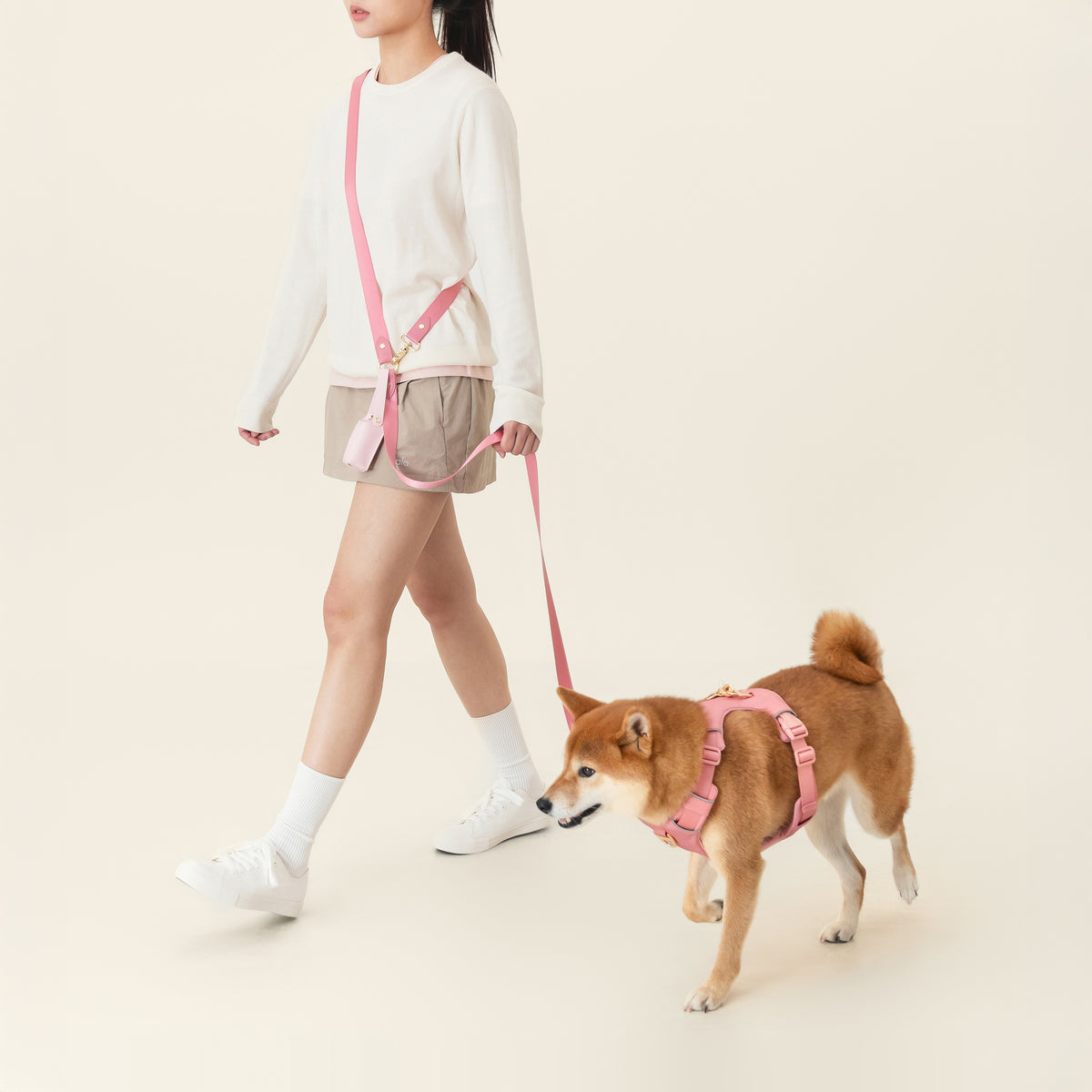 Dog wearing the Baby Pink harness with the matching crossbody leash