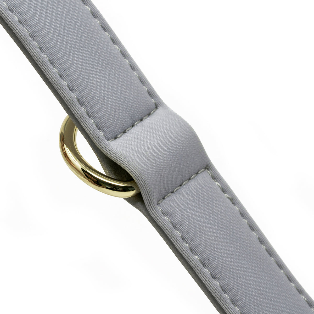 Close-up detail of the Pearl Gray dog collar featuring soft foam padding and gold D-ring hardware.
